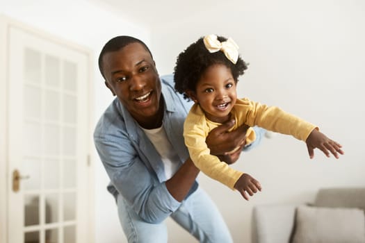 Handsome young african american father have fun with his daughter