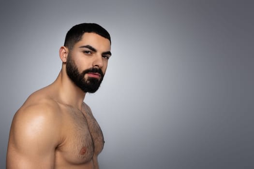 Portrait of attractive muscular middle eastern man with naked torso