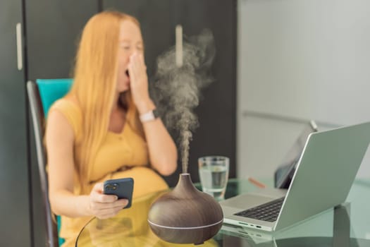 Expectant woman enhances work environment, using an aroma diffuser for a soothing atmosphere during pregnancy