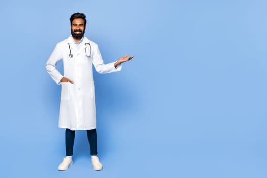 Indian male doctor gesturing with hand on blue background