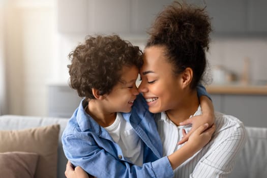 Black mother and son sharing tender nose-to-nose moment