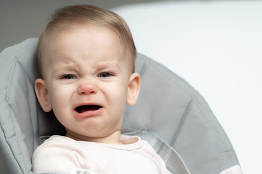 Portrait of crying toddler baby upset of being hungry and tired