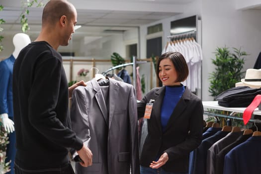 Seller showcasing jacket to client
