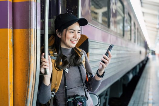 Woman using mobile phone while travel by train. travel concept