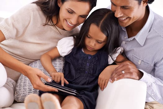 Happy family, tablet and sofa for entertainment, social media or reading ebook together at home. Mother, father and daughter on technology for online streaming, movie or internet on couch at house