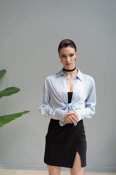 young beautiful woman standing in a shirt in the studio