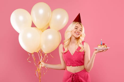 Joyful young blonde lady with balloons and birthday cake, party mood