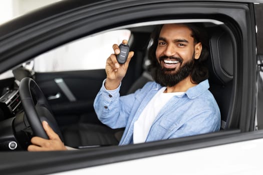 Indian man in casual outfit sitting inside nice white car