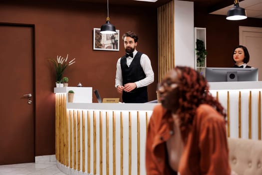Hotel receptionist working at front desk