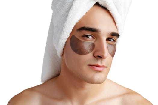 Portrait of attractive young male model with eye patches on white background