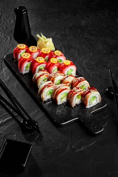 Philadelphia sushi rolls with tuna and eel on serving board