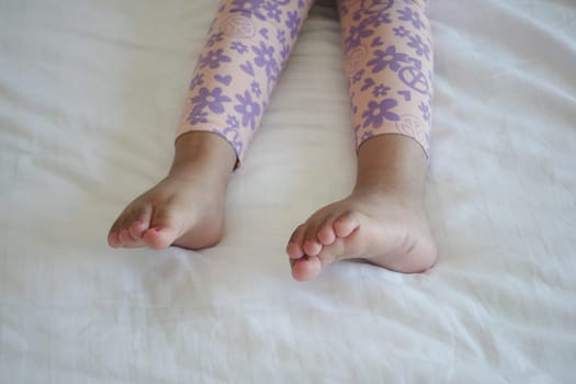 5 year old child girl feet on bed