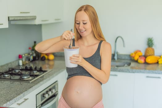 Happy pregnant young woman eating ice cream