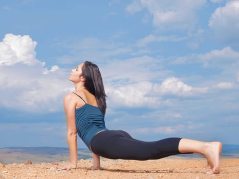 Woman, yoga and stretching on mountain or peace as wellness zen or outdoor nature, pilates or blue sky. Female person, relax and countryside in America or mindfulness practice, balance or performance