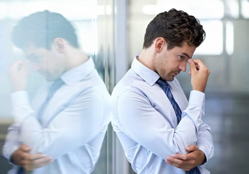 Headache, stress and business man with burnout, tired or anxiety for financial crisis in office. Frustrated, depression and serious professional with fatigue, thinking or fail with regret for mistake