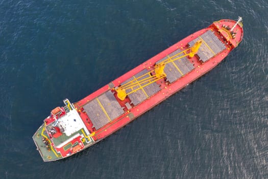 Aerial top view of cargo ship vessel import export sailing.