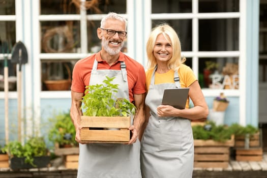 Portrait Of Happy Mature Greenhouse Owners Couple Posing Outdoors Together