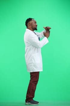 The doctor, in full height, on a green background, shows a pause sign