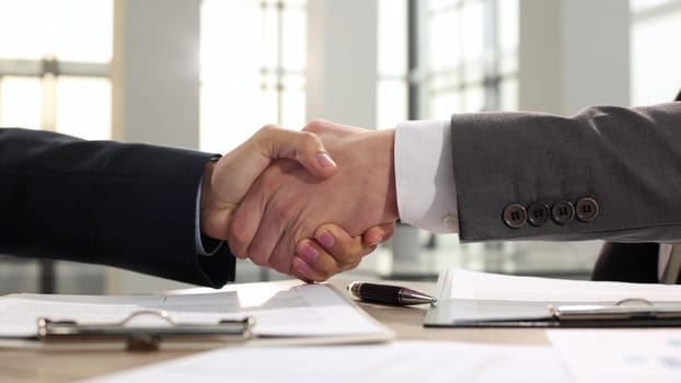 Handshake and congratulations after the transaction