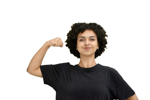 A woman, close-up, on a white background, shows strength