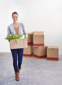 Portrait, new home and woman with boxes, moving and real estate with rental apartment and property. Person, plant and girl with achievement and personal development with package and house on a loan