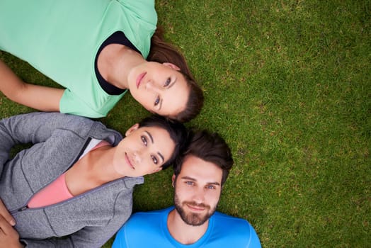 Top view, group of people on grass and portrait for fitness, relax after workout for health and wellness together. Exercise, training club for sports and active in nature, support and trust outdoor