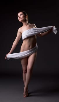 Nude woman posing with cloth covering her body