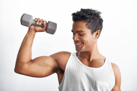 Gym, fitness and happy man with dumbbell in studio for weightlifting, sports or resilience on white background. Training, face or male bodybuilder with space for power, performance or bicep challenge