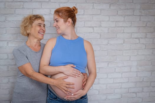 Elderly woman and her adult pregnant daughter.