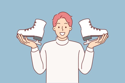 Man holds pair of ice skates in hands, inviting you to sign up for figure skating or hockey courses