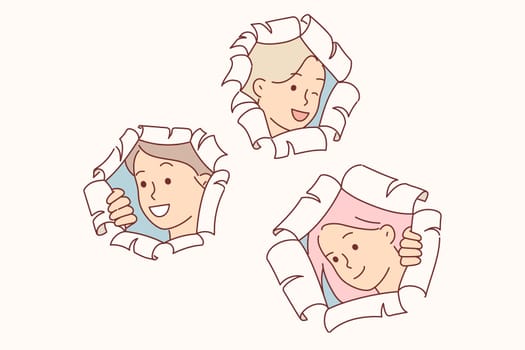 Happy schoolgirls make surprise by peeking out of holes in papers and peeking at you with curiosity