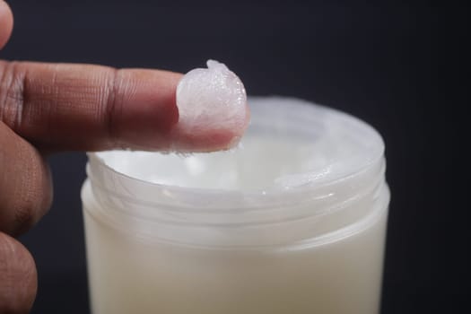 Close up of man hand using petroleum jelly