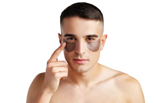Portrait of attractive young male model with eye patches on white background