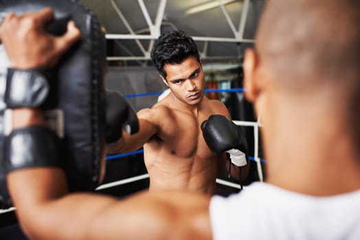 Boxer, man and coach in boxing ring with punching bag for training, workout and performance with fight or fitness. Professional, athlete and exercise for competition, match or sport with healthy body