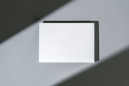 White notepad with hard cover on gray background