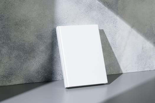 White notepad with hard cover on gray background