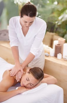 Spa, woman and masseuse with massage for relax, luxury treatment and satisfaction with towel outdoor. Person, face and wellbeing for body care, pain relief and comfort with wellness and skincare