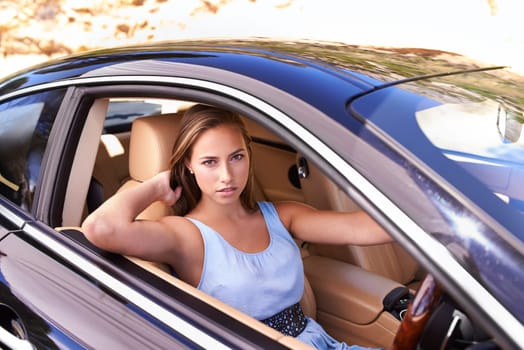 Portrait, travel and woman in sports car, driving or road trip with motor vehicle in Canada. Serious person, face and luxury automobile for journey, vacation and adventure in transport for holiday.