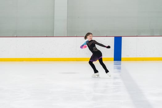 Figure skating practice at an indoor skating rink