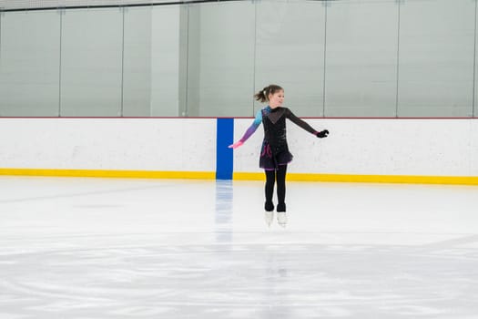 Figure skating practice at an indoor skating rink