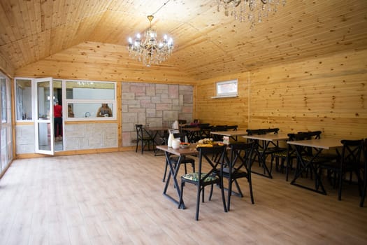 Rustic wooden interior of a cozy restaurant with tables and chairs