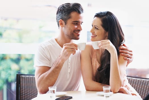 Date, coffee and couple at cafe with happy, smile and love together with toast and hot drink at a table. Espresso, morning and marriage at a restaurant with bonding, care and romance on patio.