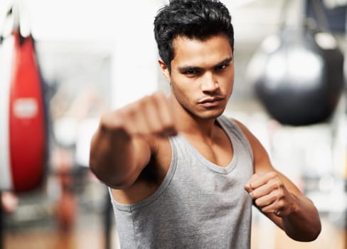 Man, portrait and training with confidence, boxing and fists ready to punch in match for health and exercise. Male person, workout and focus in gym, mma and boxer for sports and combat for defence