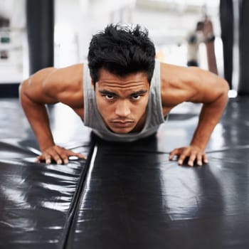 Mexican man, strong and training for fitness, sport and health for boxer on mat with pushups. Male person, wellness and exercise for workout, athlete and cardio strength for commitment in boxing gym