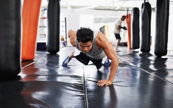 Man, pushups and training for fitness, sport and health for being a boxer on mat with one arm. Male person, wellness and exercise for workout, athlete and cardio strength for commitment in boxing gym
