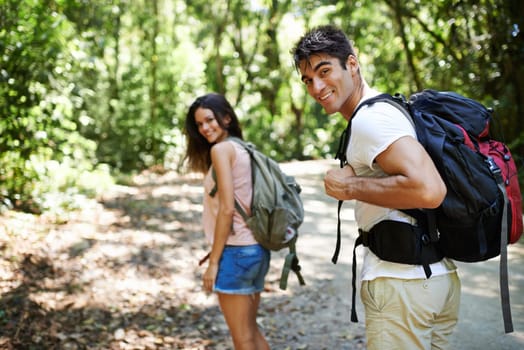 Hiking, walking and portrait of couple in nature for adventure, fitness and explore with backpack outdoors. Forest, travel and man and woman on trail for holiday, vacation and trekking for wellness.