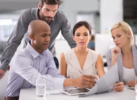 Business people, documents and paperwork in team discussion for meeting or collaboration at office. Young employees or colleagues brainstorming, reading schedule or planning project at workplace.
