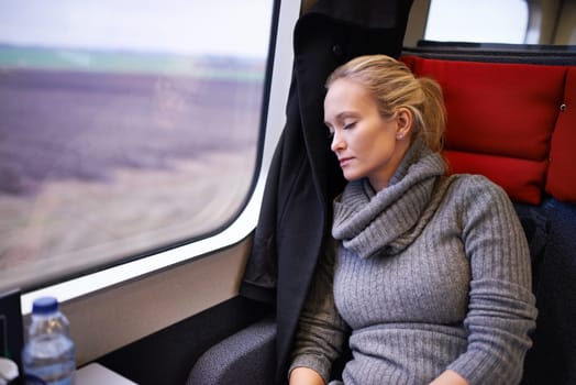 Woman, train and sleep with travel or relax journey for holiday destination for tired, transportation or resting. Female person, window and commute in Canada with nap for peace, comfortable or trip