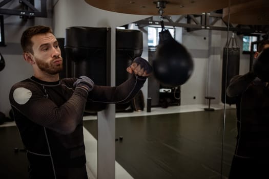 Boxer focused on improving punch accuracy speed bag in gym