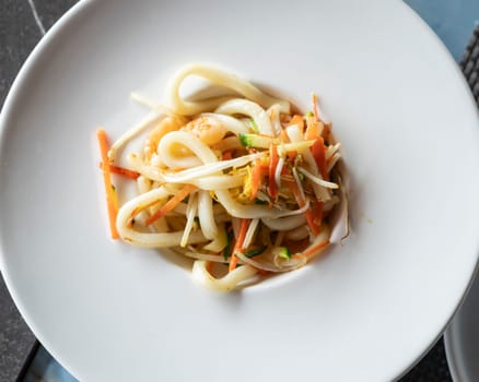 Stir-fried Yaki Udon noodles with shrimps seafood and vegetables over view